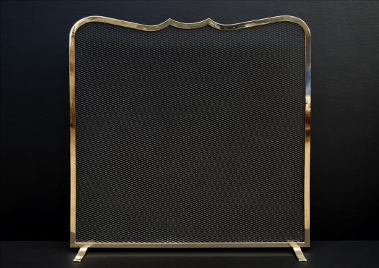 An elegant brass firescreen