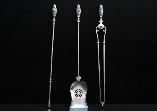 A set of 19th century polished antique steel firetools