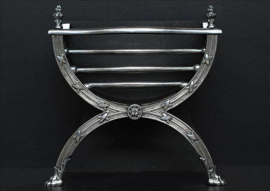 A elegant Regency style polished cast iron firegrate