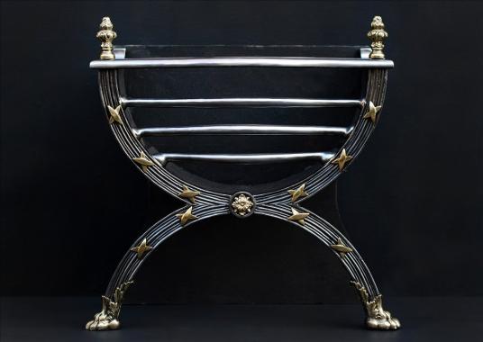 A elegant Regency style polished cast iron and brass firegrate