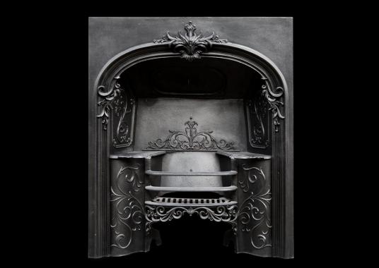 A decorative mid 19th century cast iron register grate