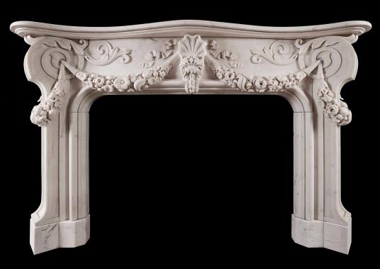 An ornately carved Italian Statuary marble fireplace