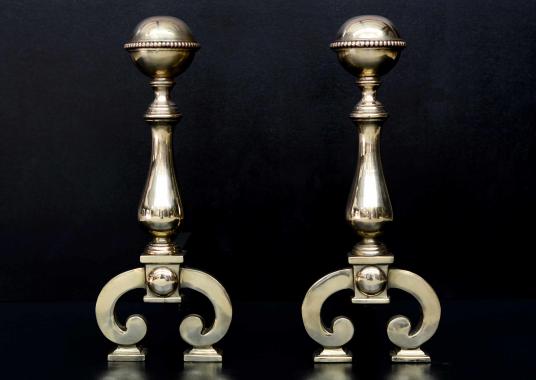 A pair of polished brass firedogs with beading to top