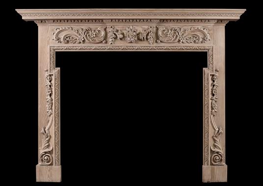 A Georgian style carved pine fireplace