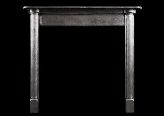 A simple polished cast iron fireplace