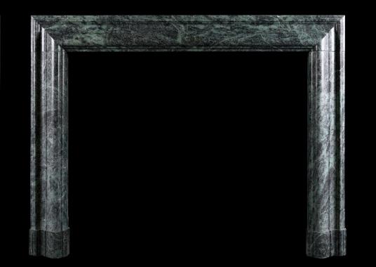 A Queen Anne style bolection fireplace in green marble