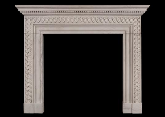 A white marble fireplace with guilloche carving