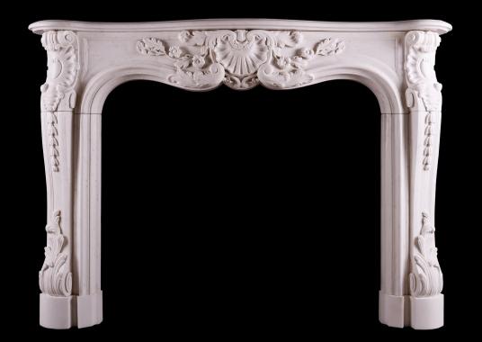 A heavily carved French Louis XV style fireplace