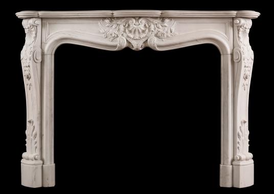 An ornately carved Louis XV marble fireplace