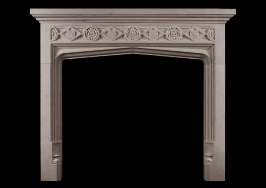 A Gothic style limestone fireplace