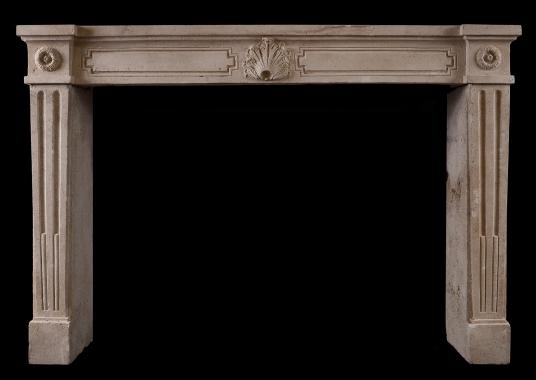 A rustic French Louis XVI antique fireplace