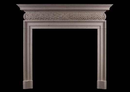 A mid 18th century style antiqued limestone fireplace