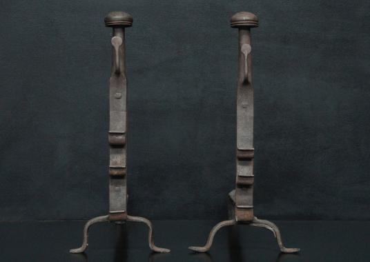 A pair of wrought iron firedogs