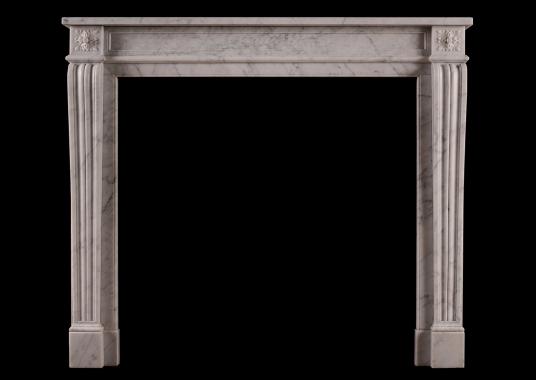 A 19th century carved marble fireplace in the Louis XVI style