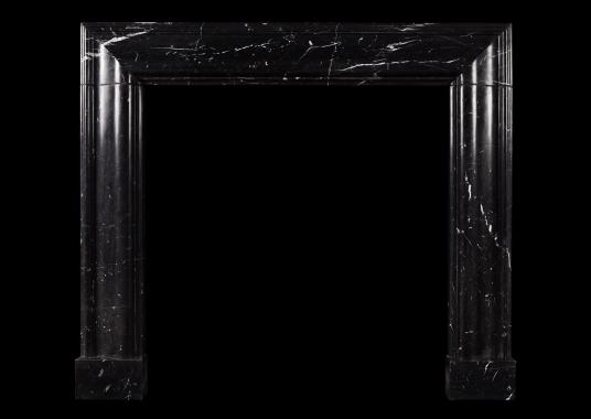 An English moulded bolection fireplace in Nero Marquina marble