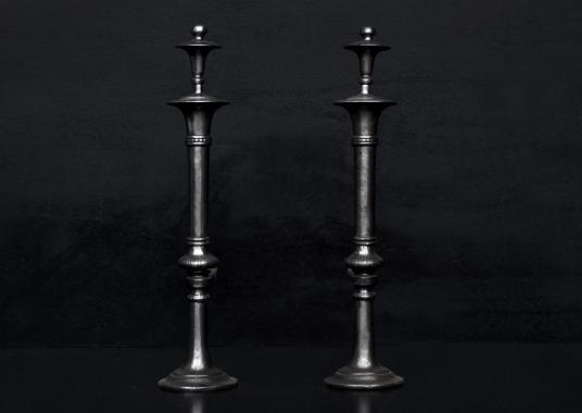 A pair of polished cast iron firedogs