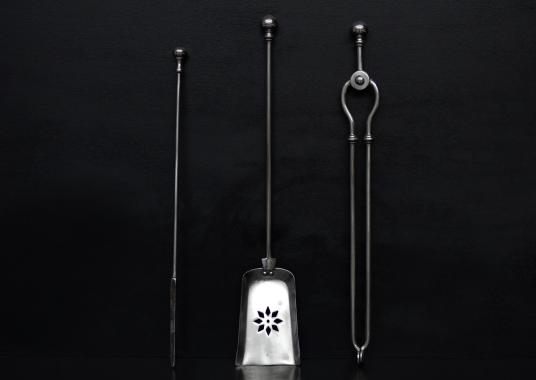 A set of polished steel firetools