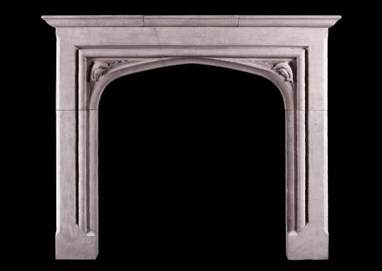 A small scale Gothic fireplace with carved dolphins