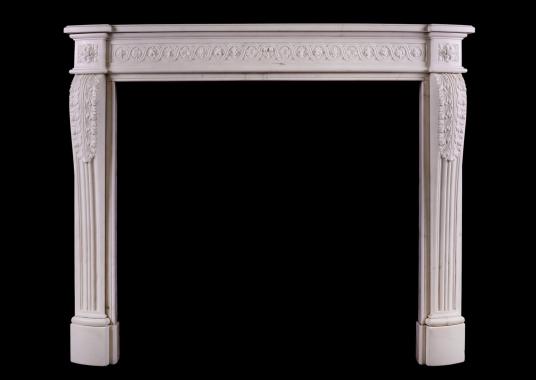 A carved French fireplace with guilloche frieze