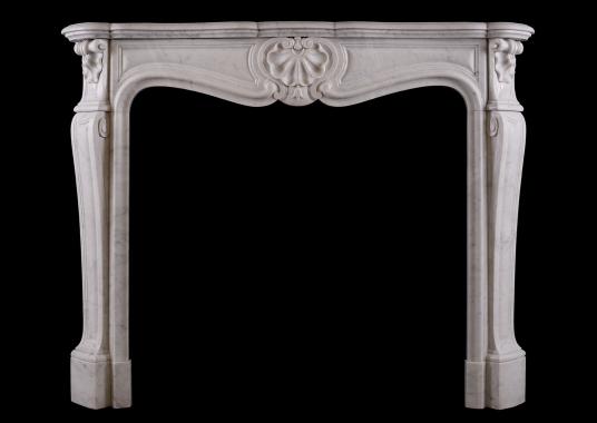 A French Louis XV style fireplace in Italian Carrara marble