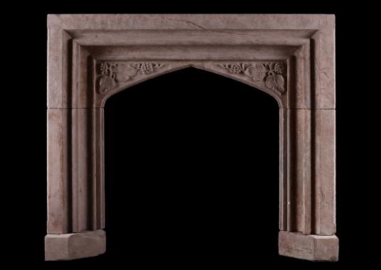 A carved stone fireplace in the Gothic manner