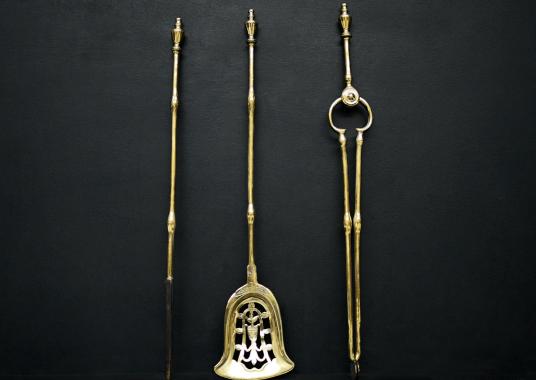 A set of brass firetools