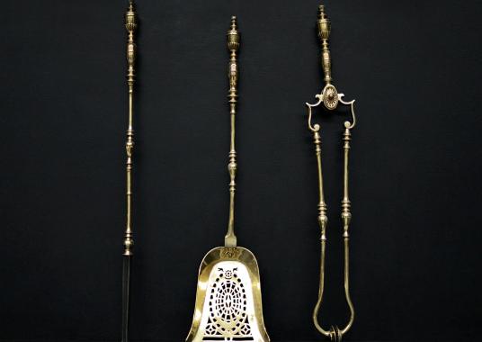 A set of brass firetools