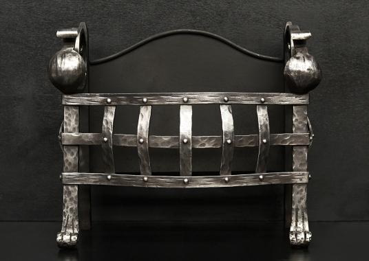 A small Gothic style wrought iron firegrate