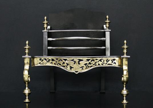 A decorative brass and steel firegrate