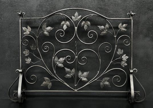 A pretty wrought iron firescreen