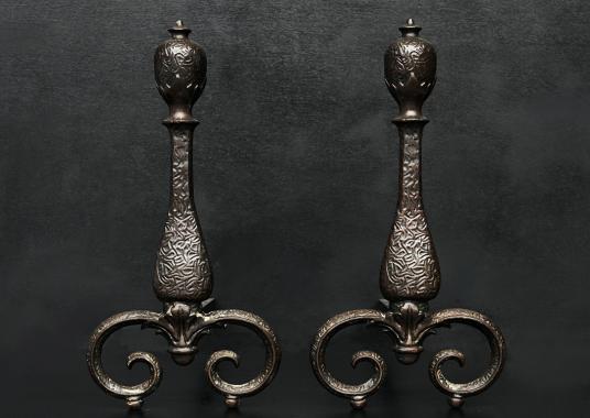 A decorative pair of iron firedogs