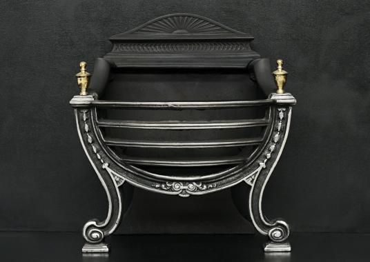 A polished cast iron Adam style basket