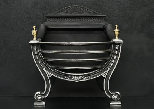 A polished cast iron Adam style basket