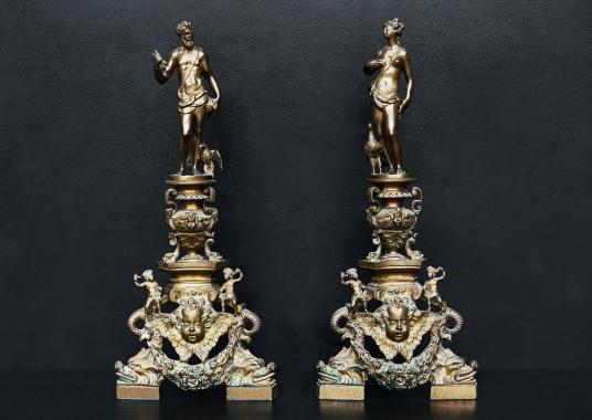 An ornate pair of brass firedogs