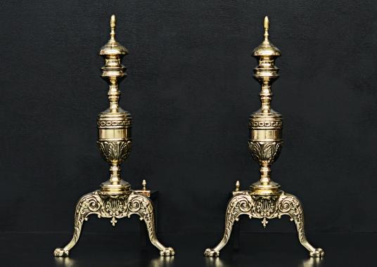 A pair of Regency style brass firedogs