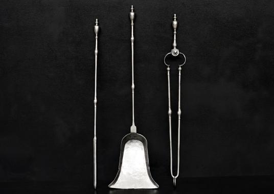 A set of polished steel firetools