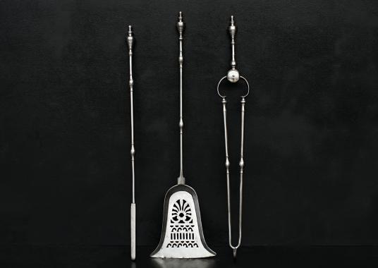 A set of polished steel firetools in the Georgian manner