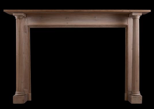 A columned pine fireplace in the Georgian manner