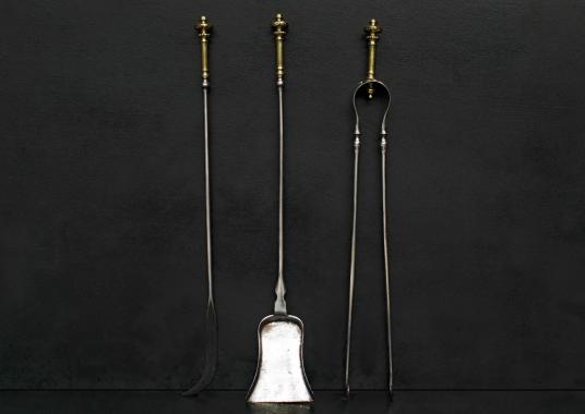 A set of brass and steel firetools.