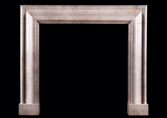 A bolection fireplace in Crema Marfil marble
