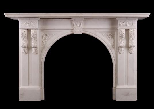 A carved arched marble fireplace