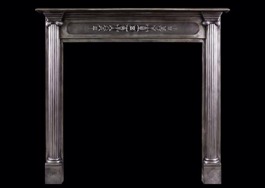 A polished cast iron fireplace in the classical style