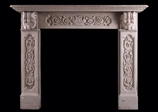 A carved English stone fireplace