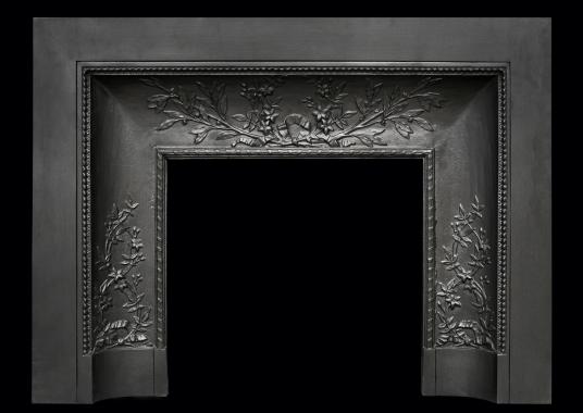 A decorative cast iron contracoeure fireplace interior