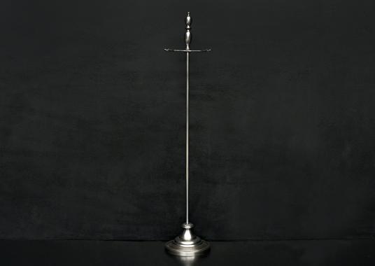 A polished steel firetool stand