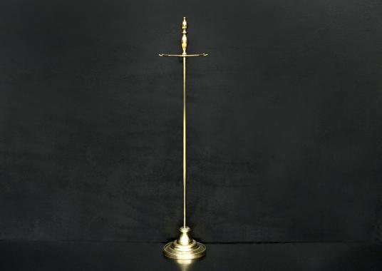 A polished brass firetool stand