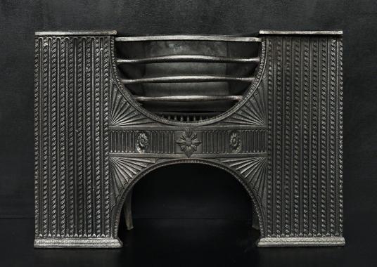 A decorative cast iron hour-glass hob grate