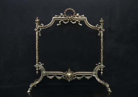 A decorative brass fireguard in the Regency style