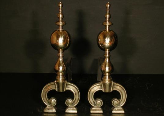 A pair of brass firedogs