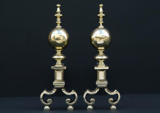 A pair of brass firedogs with ball finials